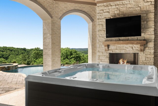 443 Canterbury Rise, Franklin, TN 37067 - view of patio with a hot tub and an outdoor stone fireplace