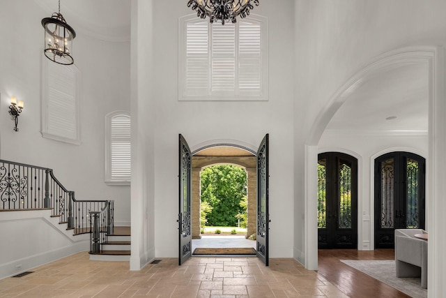 443 Canterbury Rise, Franklin, TN 37067 - foyer with a chandelier, arched walkways, a high ceiling, french doors, and baseboards