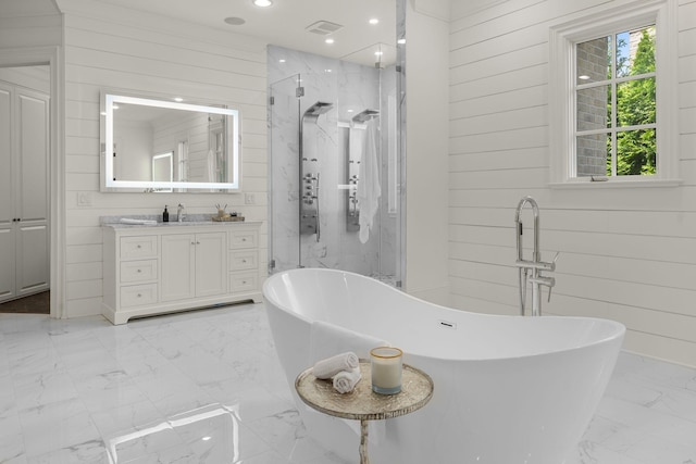 443 Canterbury Rise, Franklin, TN 37067 - bathroom featuring marble look tile flooring, a marble finish shower, vanity, wood walls, and a soaking tub