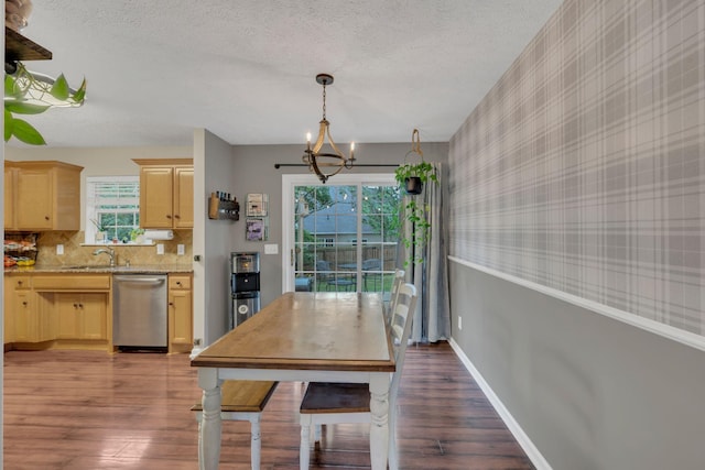 dining area featuring wallpapered walls, a textured ceiling, a chandelier, wood finished floors, and baseboards