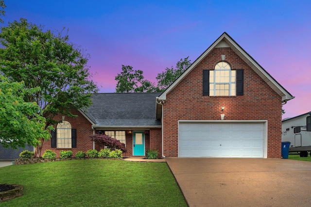 traditional home featuring driveway, brick siding, an attached garage, and a front lawn