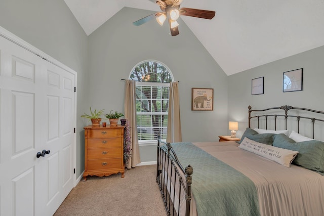 bedroom with multiple windows, light colored carpet, baseboards, ceiling fan, and high vaulted ceiling