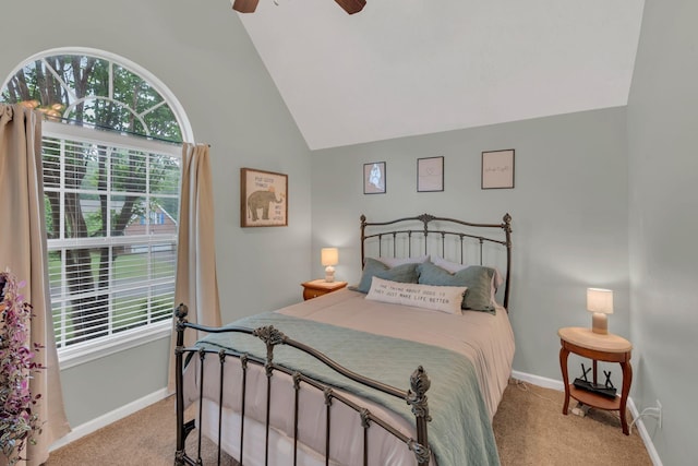bedroom featuring light colored carpet, multiple windows, vaulted ceiling, and baseboards