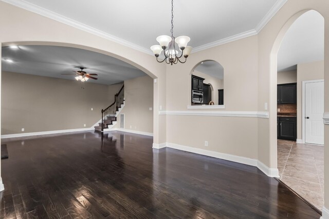 1685 Apache Way, Clarksville, TN 37042 - spare room featuring wood finished floors, ornamental molding, ceiling fan, stairs, and baseboards