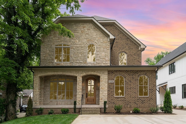 909 Gale Ln Unit A, Nashville, TN 37204 - french provincial home featuring stone siding, a porch, and brick siding