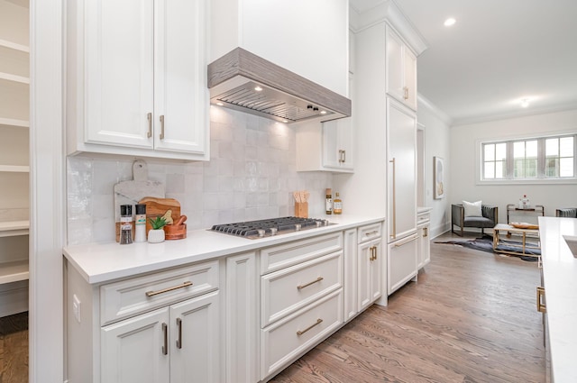 909 Gale Ln Unit A, Nashville, TN 37204 - kitchen featuring light wood-style floors, stainless steel gas stovetop, custom range hood, tasteful backsplash, and white cabinets