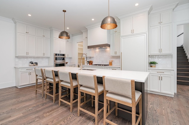 909 Gale Ln Unit A, Nashville, TN 37204 - kitchen featuring a sink, light wood finished floors, tasteful backsplash, white cabinetry, and recessed lighting