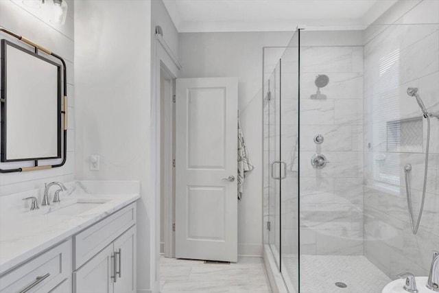 full bath with a stall shower, vanity, and marble finish flooring