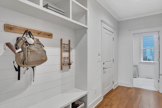 mudroom with wood finished floors and baseboards
