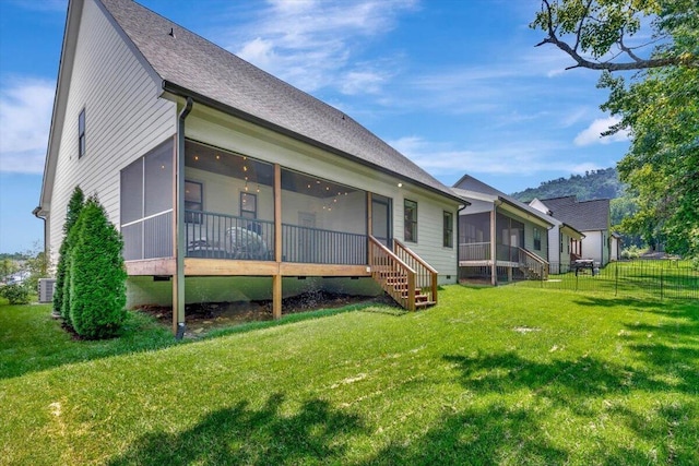rear view of house featuring a sunroom, crawl space, stairway, central AC, and a shingled roof
