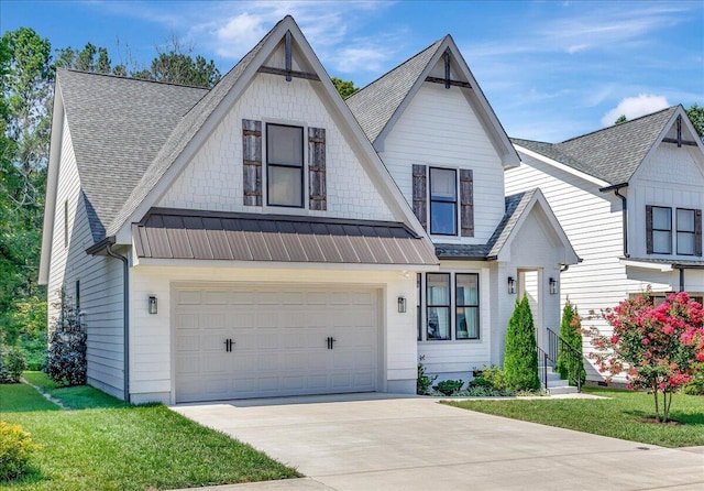 view of front of property featuring driveway, a front lawn, a shingled roof, and metal roof