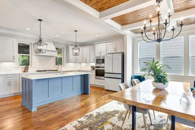 kitchen featuring appliances with stainless steel finishes, a chandelier, light countertops, tasteful backsplash, and recessed lighting