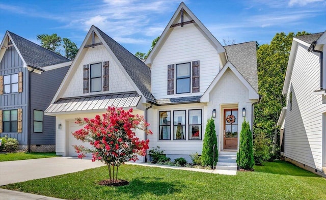 view of front of property with a standing seam roof, roof with shingles, driveway, a front lawn, and a garage