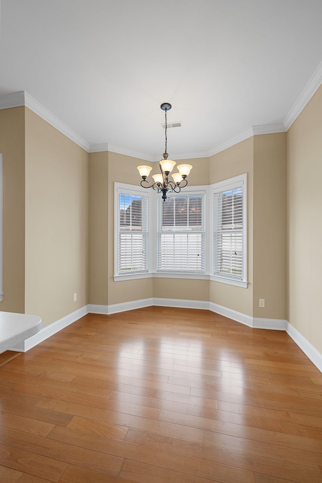 153 Magnolia Glen Cir, Manchester, TN 37355 - unfurnished room featuring a chandelier, baseboards, crown molding, and light wood-type flooring