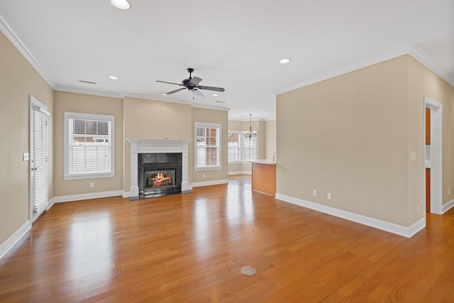 153 Magnolia Glen Cir, Manchester, TN 37355 - unfurnished living room with crown molding, ceiling fan, a fireplace with flush hearth, a chandelier, and light wood-type flooring