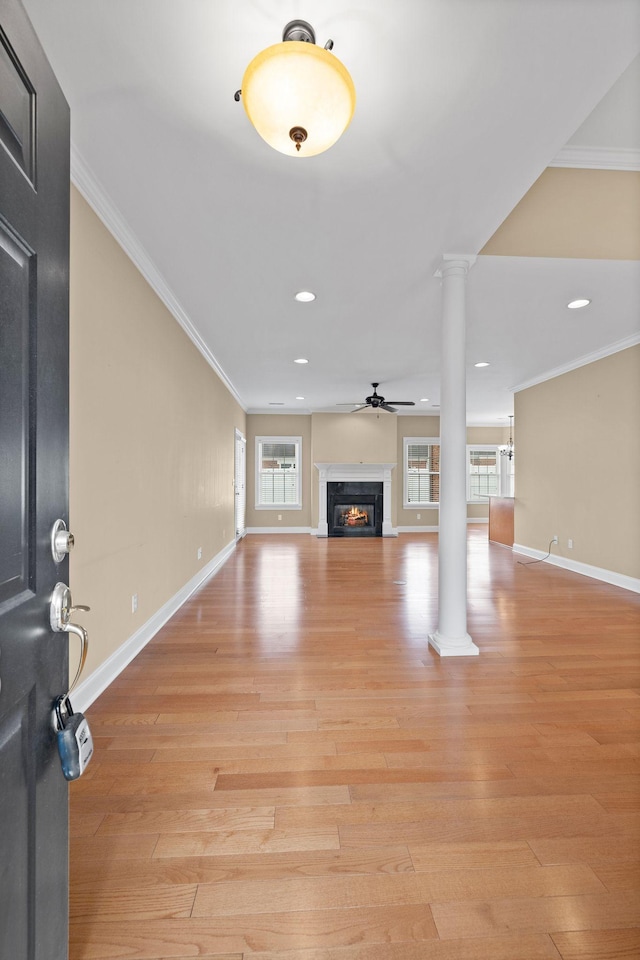 153 Magnolia Glen Cir, Manchester, TN 37355 - unfurnished living room featuring ornate columns, healthy amount of natural light, a high end fireplace, light wood-style flooring, and ornamental molding