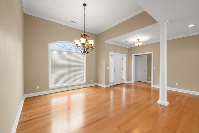 153 Magnolia Glen Cir, Manchester, TN 37355 - spare room featuring decorative columns, light wood-style floors, baseboards, crown molding, and a chandelier