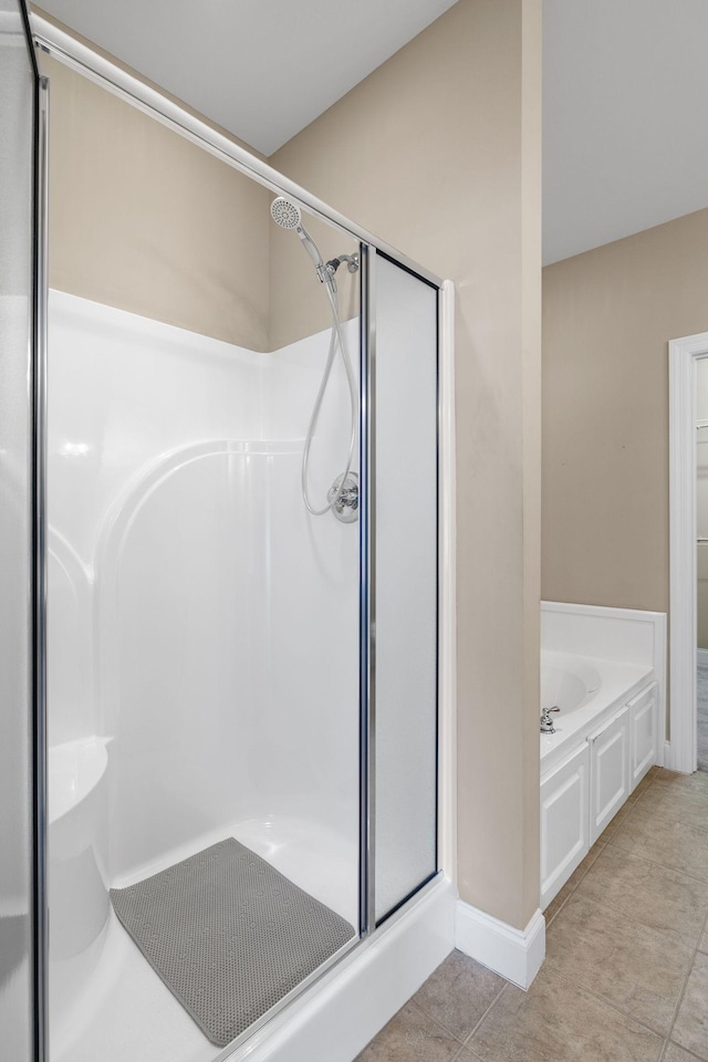 153 Magnolia Glen Cir, Manchester, TN 37355 - full bath featuring a stall shower, a garden tub, and tile patterned flooring