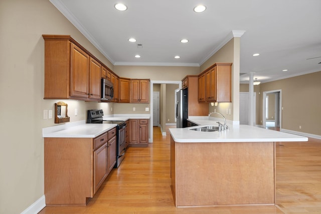 153 Magnolia Glen Cir, Manchester, TN 37355 - kitchen featuring stainless steel appliances, a sink, a peninsula, light wood-style floors, and recessed lighting