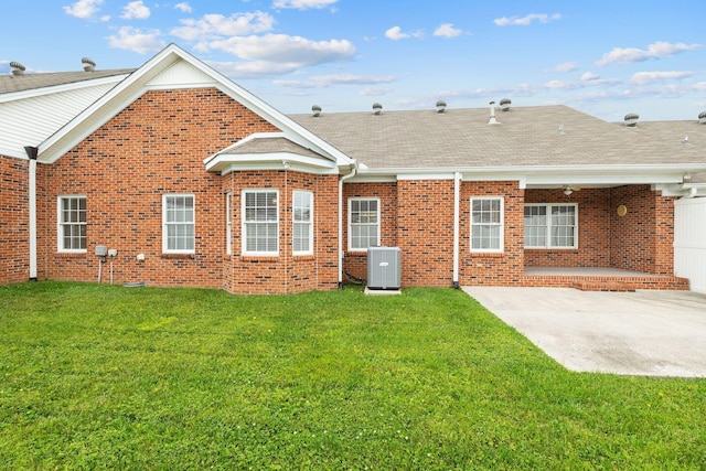 153 Magnolia Glen Cir, Manchester, TN 37355 - back of house with central AC, a patio area, brick siding, roof with shingles, and a yard