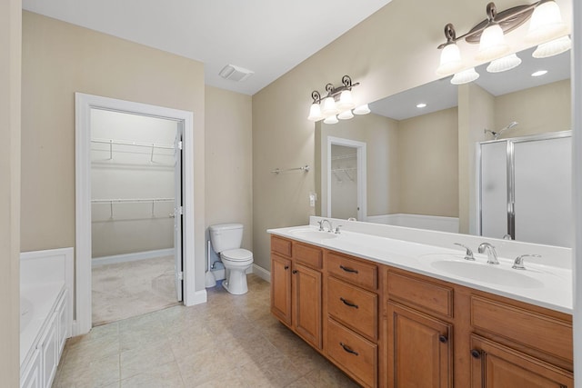 153 Magnolia Glen Cir, Manchester, TN 37355 - bathroom with toilet, a shower stall, double vanity, a tub to relax in, and a spacious closet