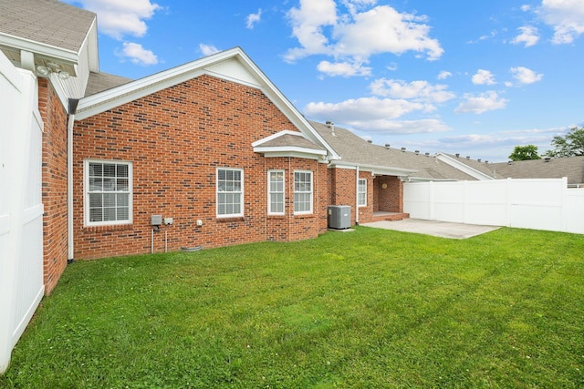 153 Magnolia Glen Cir, Manchester, TN 37355 - back of property featuring a patio, brick siding, central air condition unit, and roof with shingles