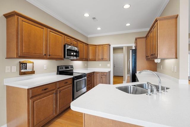153 Magnolia Glen Cir, Manchester, TN 37355 - kitchen featuring stainless steel appliances, a sink, recessed lighting, brown cabinets, and crown molding
