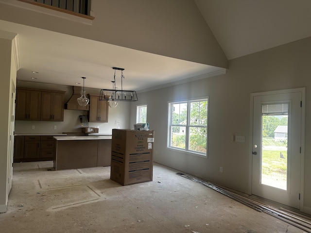 1067 Robert Lee Dr, Gallatin, TN 37066 - kitchen with a kitchen island, custom exhaust hood, crown molding, light countertops, and pendant lighting