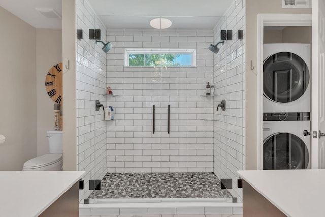 213 Hickory Trl, White House, TN 37188 - full bathroom featuring stacked washer / dryer, vanity, toilet, and a stall shower