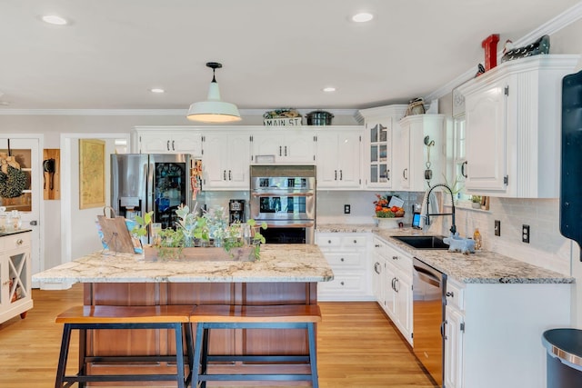 213 Hickory Trl, White House, TN 37188 - kitchen featuring stainless steel appliances, a kitchen bar, white cabinets, a sink, and tasteful backsplash