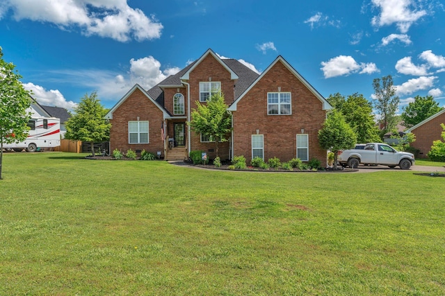 213 Hickory Trl, White House, TN 37188 - traditional-style house featuring brick siding and a front lawn