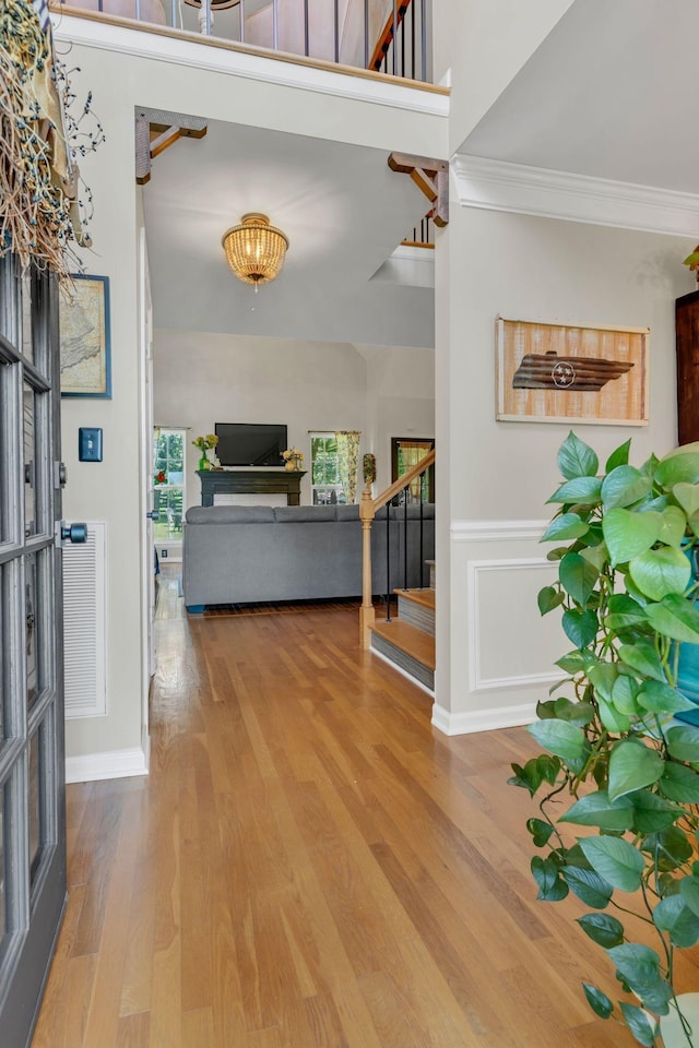 213 Hickory Trl, White House, TN 37188 - entryway featuring stairs, wood finished floors, and ornamental molding