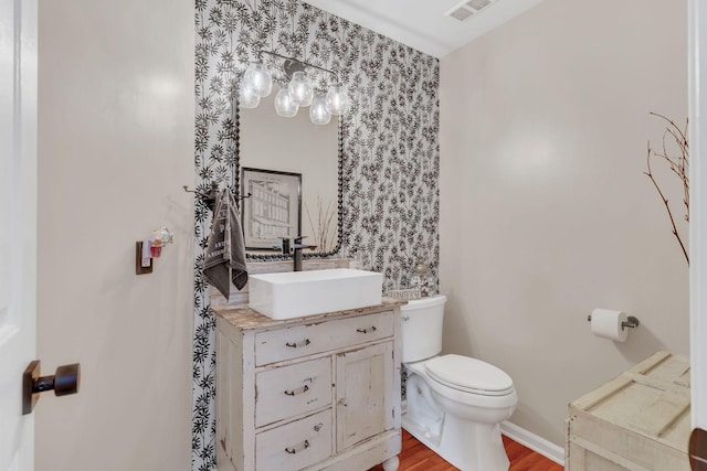 213 Hickory Trl, White House, TN 37188 - bathroom featuring toilet, wood finished floors, and vanity
