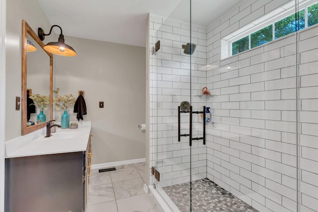 213 Hickory Trl, White House, TN 37188 - bathroom featuring marble finish floors, tiled shower, vanity, and baseboards
