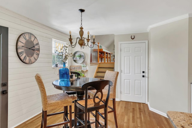 213 Hickory Trl, White House, TN 37188 - dining area featuring a chandelier, light wood-style floors, ornamental molding, baseboards, and wood walls