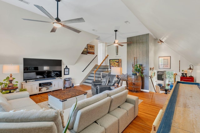 213 Hickory Trl, White House, TN 37188 - living room featuring ceiling fan, stairs, light wood-style flooring, and high vaulted ceiling