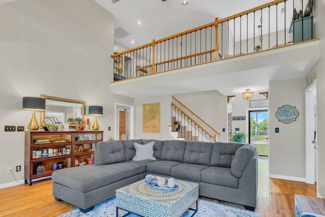 213 Hickory Trl, White House, TN 37188 - living area featuring a towering ceiling, wood finished floors, stairway, baseboards, and recessed lighting