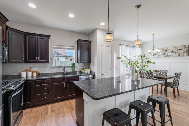 5902 Covent Ln, Smyrna, TN 37167 - kitchen featuring appliances with stainless steel finishes, a sink, a breakfast bar area, light wood-type flooring, and recessed lighting