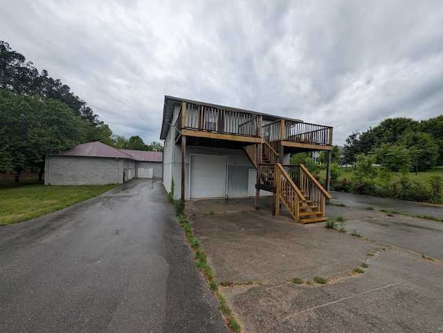 555 Oakley Allons Rd, Allons, TN 38541 - view of front of property with asphalt driveway, stairway, a garage, and a wooden deck