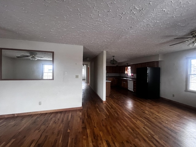 555 Oakley Allons Rd, Allons, TN 38541 - unfurnished living room with a ceiling fan, dark wood-type flooring, baseboards, and a textured ceiling