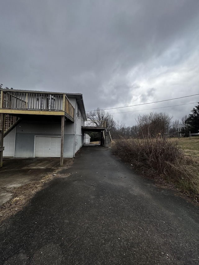 555 Oakley Allons Rd, Allons, TN 38541 - view of side of property with driveway, stairs, a garage, and a wooden deck