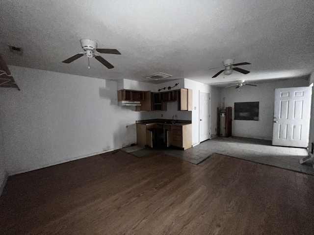 555 Oakley Allons Rd, Allons, TN 38541 - unfurnished living room featuring ceiling fan, wood finished floors, a textured ceiling, a sink, and water heater