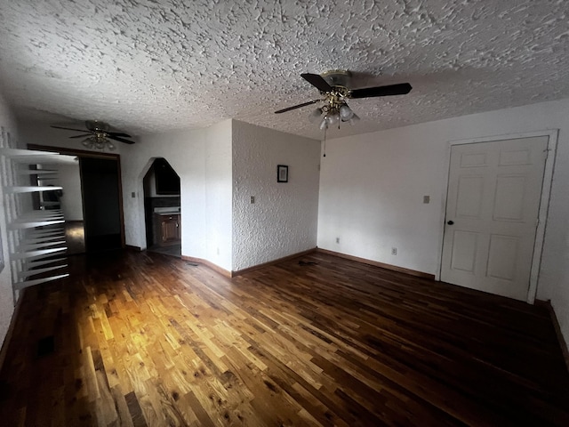 555 Oakley Allons Rd, Allons, TN 38541 - unfurnished living room with ceiling fan, wood finished floors, a textured ceiling, arched walkways, and a textured wall