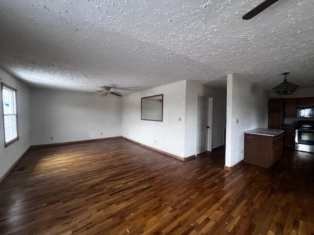 555 Oakley Allons Rd, Allons, TN 38541 - unfurnished living room with dark wood-style floors, a ceiling fan, a textured ceiling, baseboards, and a chandelier