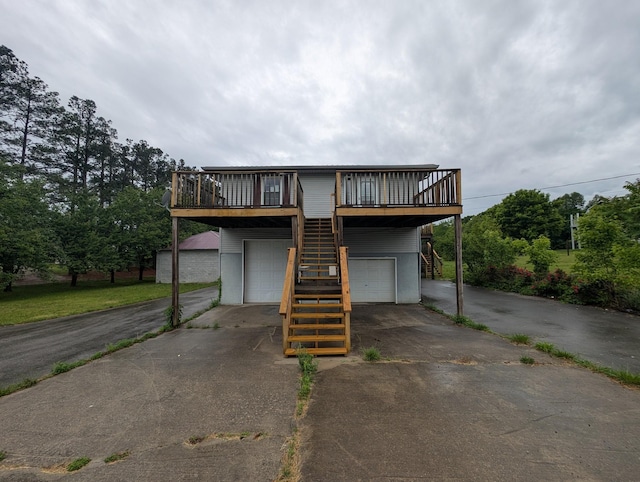 555 Oakley Allons Rd, Allons, TN 38541 - view of front of property with stairway, asphalt driveway, an attached garage, and a deck