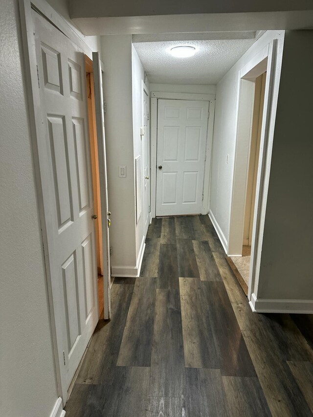 2514 Maplewood Dr, Chattanooga, TN 37421 - corridor with dark wood-style floors, baseboards, and a textured ceiling