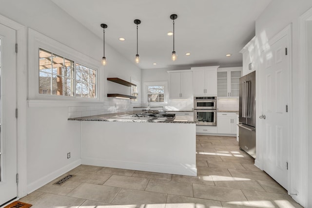 3033 Tybee Trl, Murfreesboro, TN 37127 - kitchen featuring appliances with stainless steel finishes, a peninsula, stone countertops, backsplash, and recessed lighting