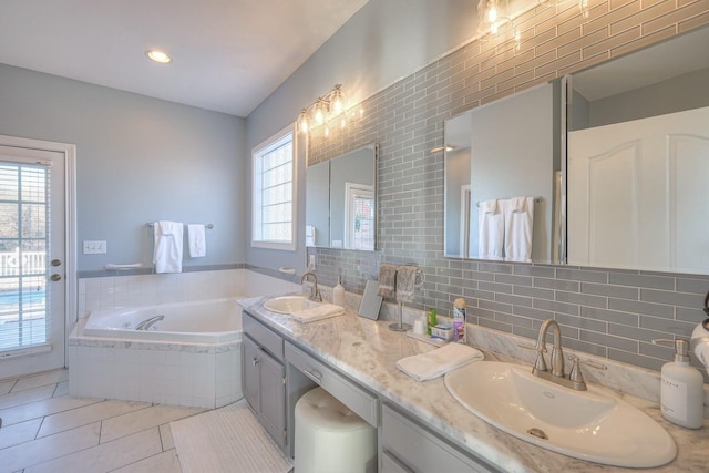 5784 Rock Springs Rd, Smyrna, TN 37167 - bathroom featuring a bath, tile patterned flooring, tasteful backsplash, and double vanity