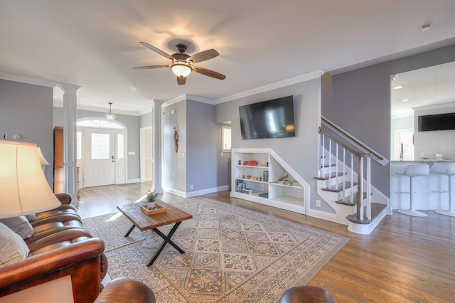 5784 Rock Springs Rd, Smyrna, TN 37167 - living area featuring wood finished floors, ceiling fan, crown molding, decorative columns, and stairway