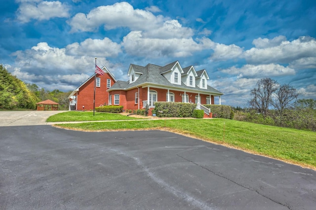 5784 Rock Springs Rd, Smyrna, TN 37167 - cape cod-style house with brick siding, a front yard, driveway, and covered porch